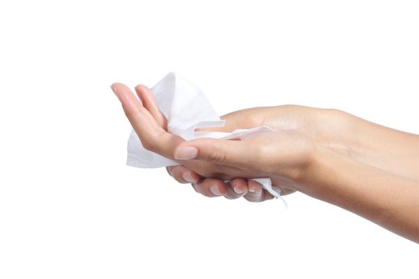 Woman cleaning her hands with a tissue Woman cleaning her hands with a tissue isolated on a white background